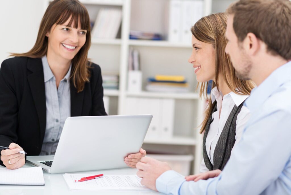 lawyer helping out clients using laptop