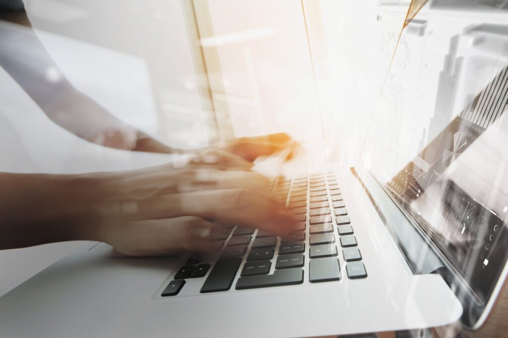 person typing on laptop on desk