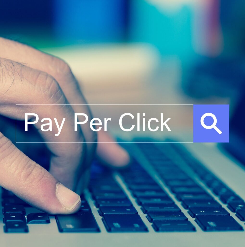 pay per click ads hands typing on laptop keyboard search